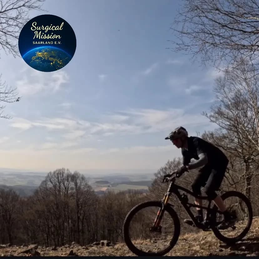 Mountain biker on a hilltop, image for Dr. Andreas Grimme's charity ride