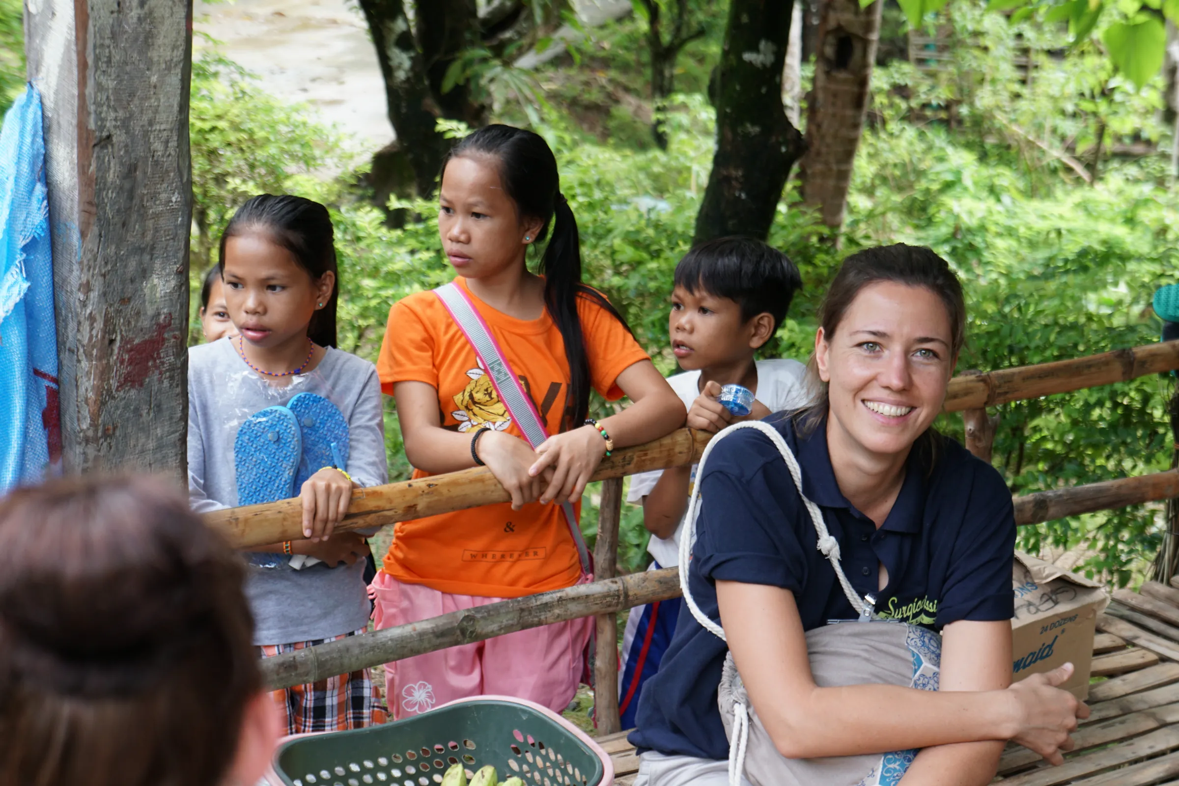 A volunteer of the association with children in a village on Mindoro, 2017