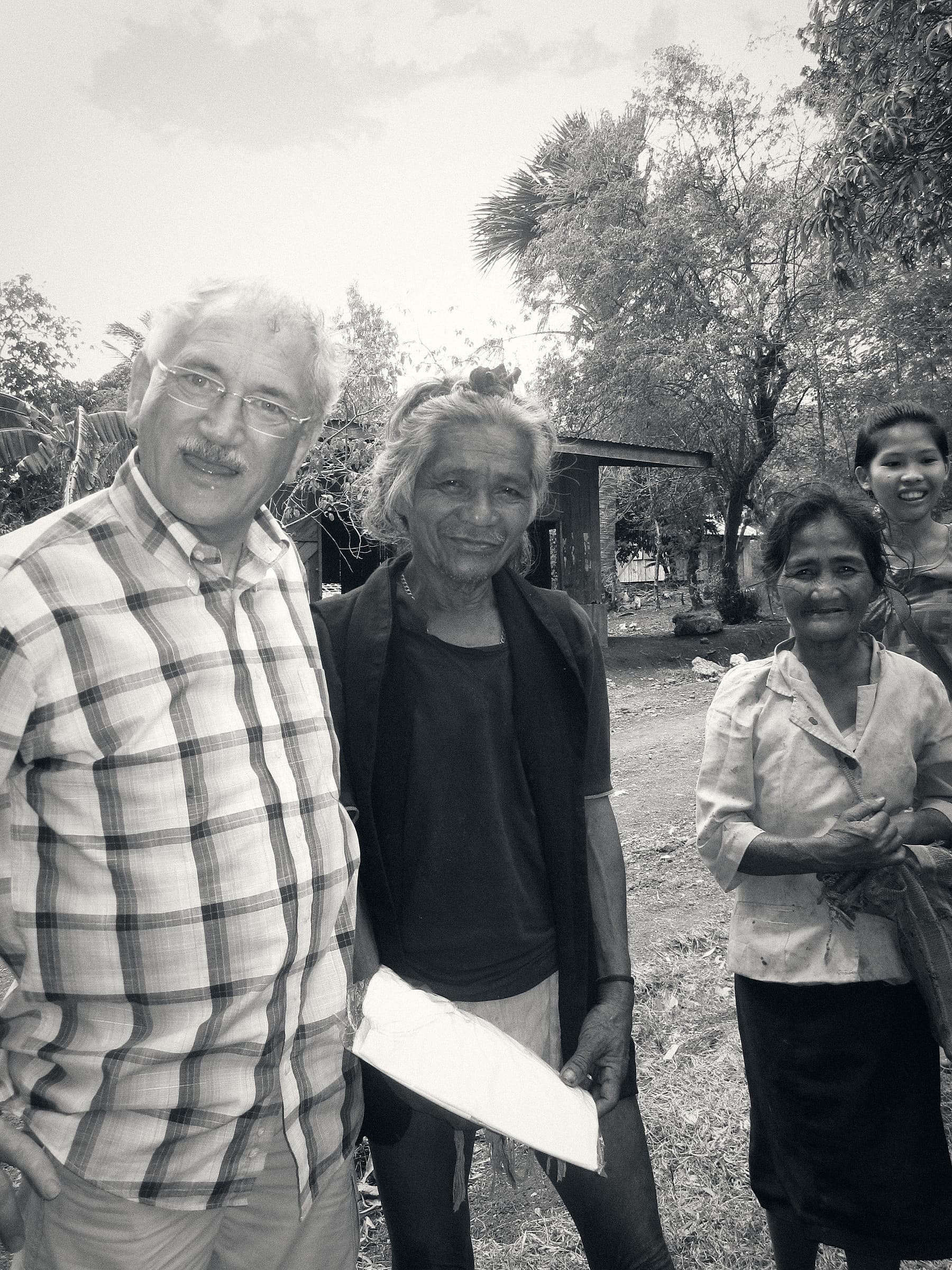 A member of the association with villagers in the Philippines